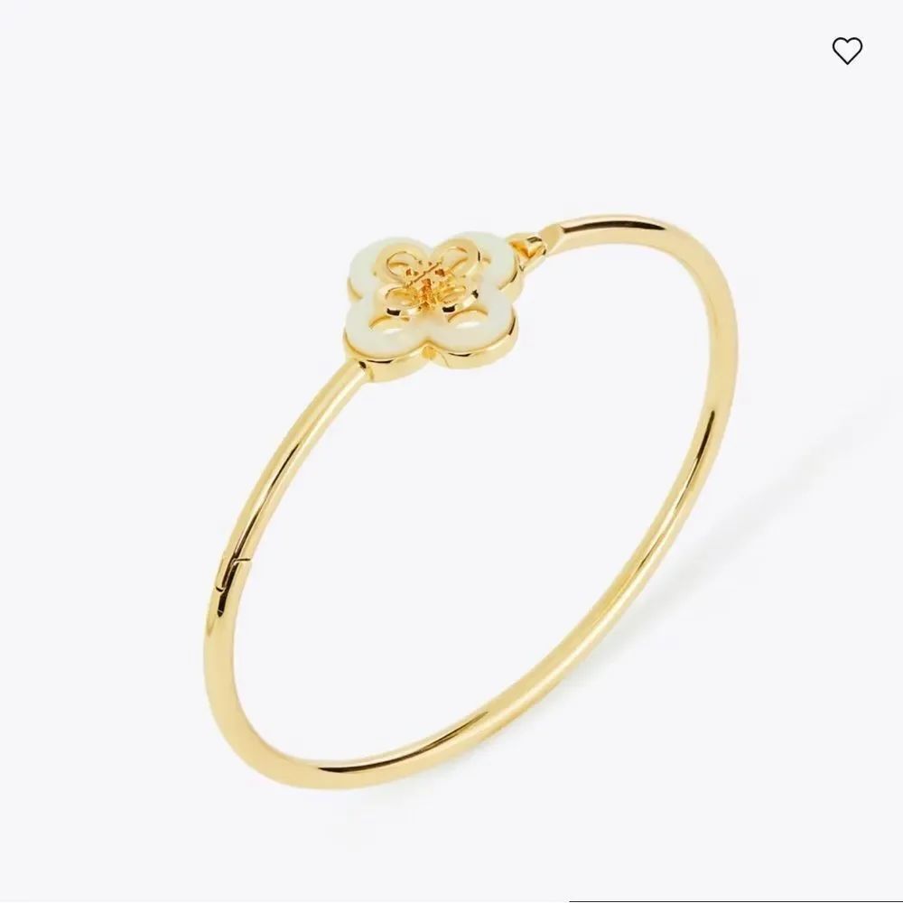 Tory Burch Kira Clover Hinge Bracelet with a mother of pearl clover charm